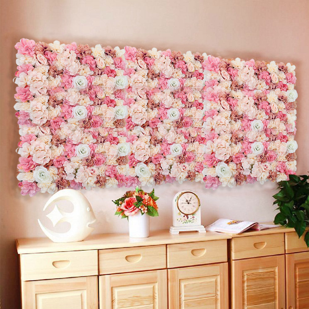 An artificial rose flower backdrop wall panel mounted on a wall, with a floral design consisting of pink and white roses.