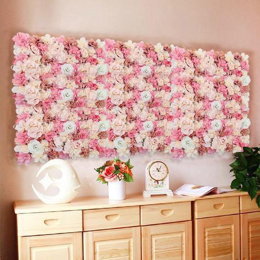 An artificial rose flower backdrop wall panel mounted on a wall, with a floral design consisting of pink and white roses.